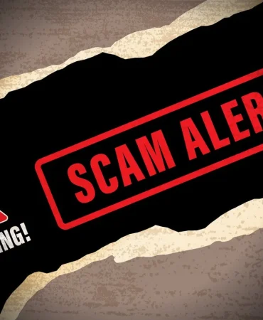 red-triangle-with-warning-underneath-next-to-scam-alert-in-red