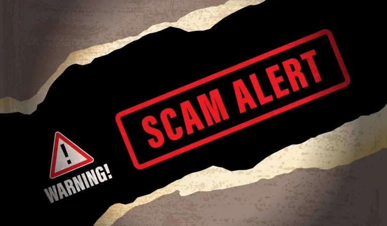 red-triangle-with-warning-underneath-next-to-scam-alert-in-red